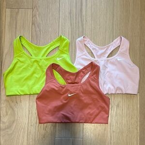 Nike Sports Bras in Lime Green, Light Pink, and Rust